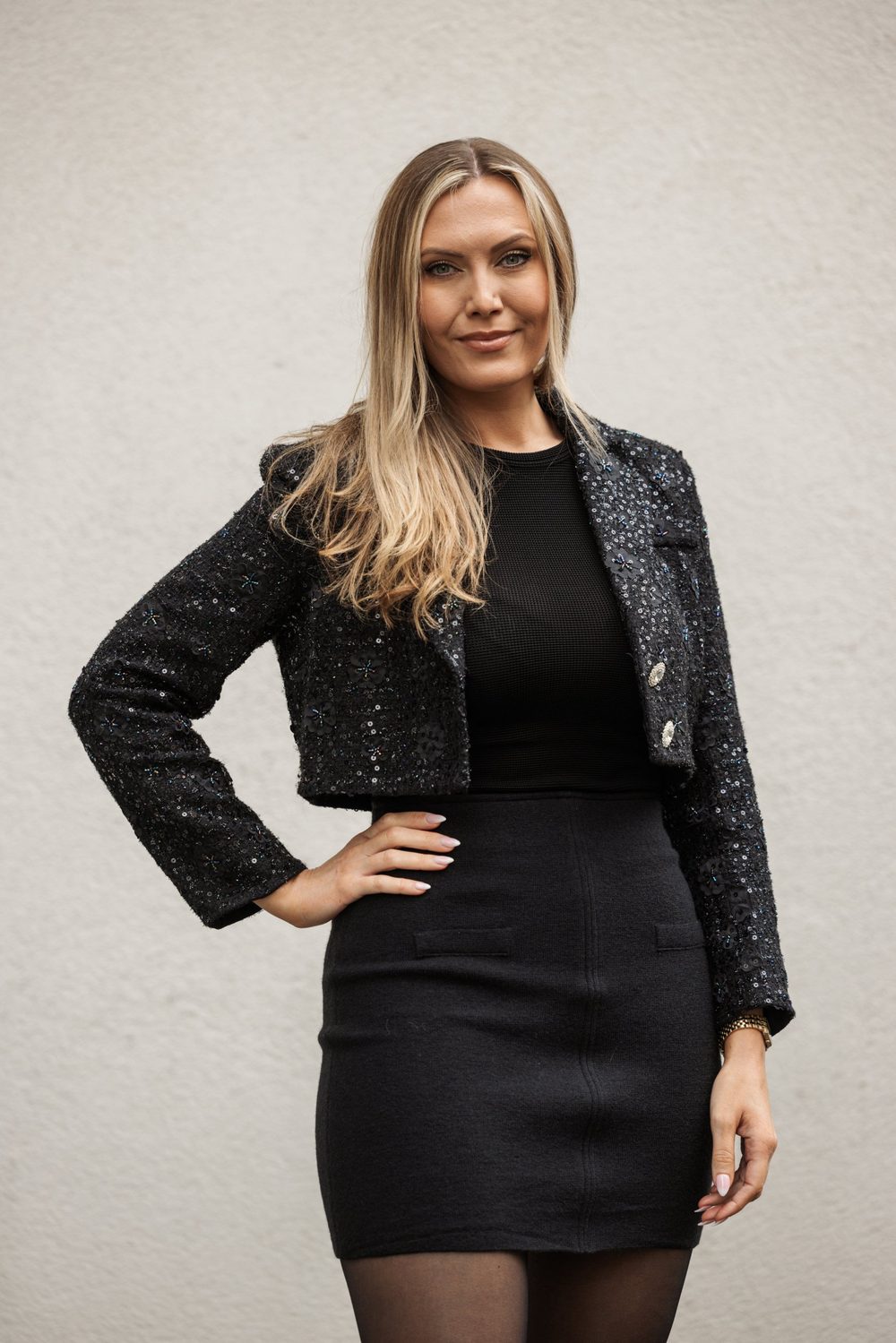 Helene Winther in a black sequin jacket with her hand on her hip